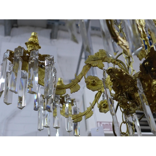 452 - Gilt metal eight branch chandelier, decorated in grape leaves, with glass drops, approximately 50 x ... 