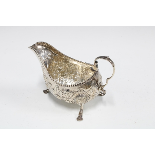 27 - Edwardian Irish silver cream jug, with birds and flower decoration, West & Son, Dublin 1903, 15cm lo... 