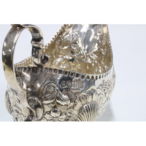27 - Edwardian Irish silver cream jug, with birds and flower decoration, West & Son, Dublin 1903, 15cm lo... 