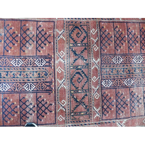 281 - Eastern rug, worn red field with geometric motifs, 262 x 172cm.