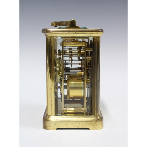 300 - Brass and glass cased carriage clock of large proportions, 18cm high including handle