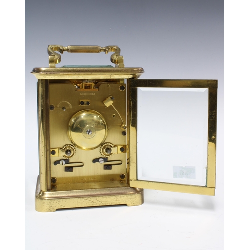 300 - Brass and glass cased carriage clock of large proportions, 18cm high including handle