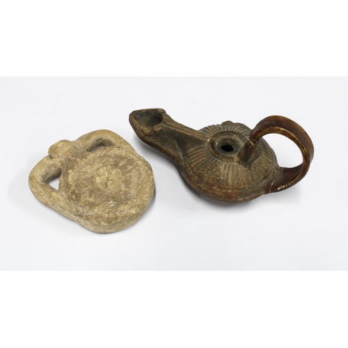 304 - Votive oil flask, 7.5cm high,  and a small oil lamp (2)