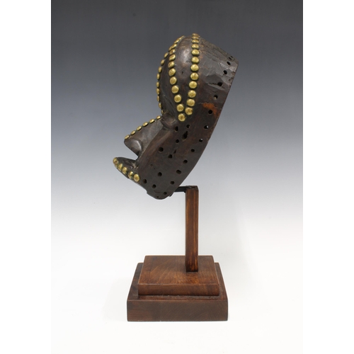 305 - Dan Mask, Liberia, wooden with brass studwork, on a display plinth, 26cm.  Private collection, Franc... 