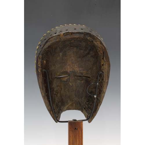 305 - Dan Mask, Liberia, wooden with brass studwork, on a display plinth, 26cm.  Private collection, Franc... 