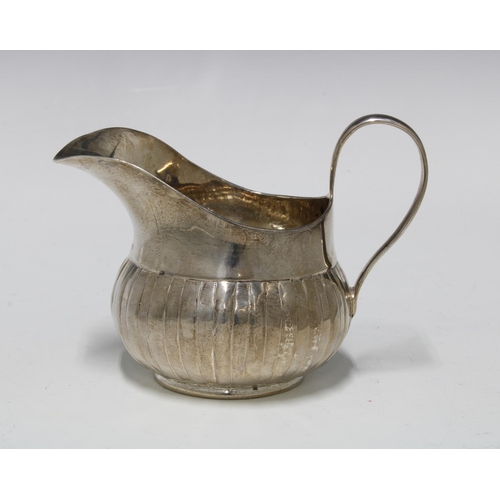 31 - George III Irish silver cream jug, with fluted base, Dublin 1760, 9cm high