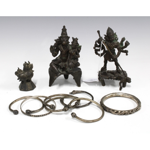 316 - Two bronze deity figures, 13cm high, a small bronze animal and a collection of bangles (a lot)