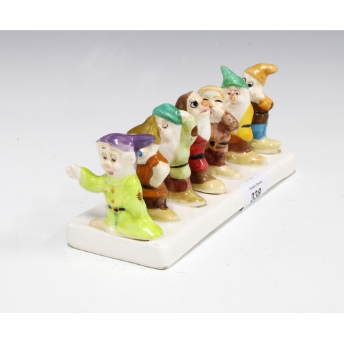 338 - Snow White and the Seven Dwarfs pottery toast rack 20cm long