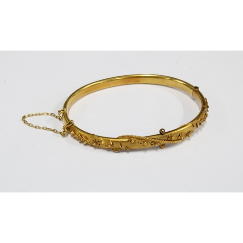 73 - Victorian 15ct gold bangle with applied floral pattern, in fitted box, stamped 15ct