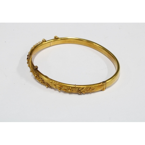 73 - Victorian 15ct gold bangle with applied floral pattern, in fitted box, stamped 15ct