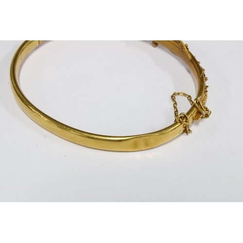 73 - Victorian 15ct gold bangle with applied floral pattern, in fitted box, stamped 15ct