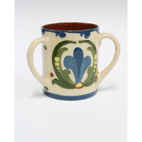 140 - Torquay Ware Scandy pattern motto loving cup, inscribed Isn't your life extremely flat.  Without wha... 