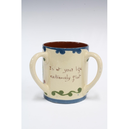 140 - Torquay Ware Scandy pattern motto loving cup, inscribed Isn't your life extremely flat.  Without wha... 