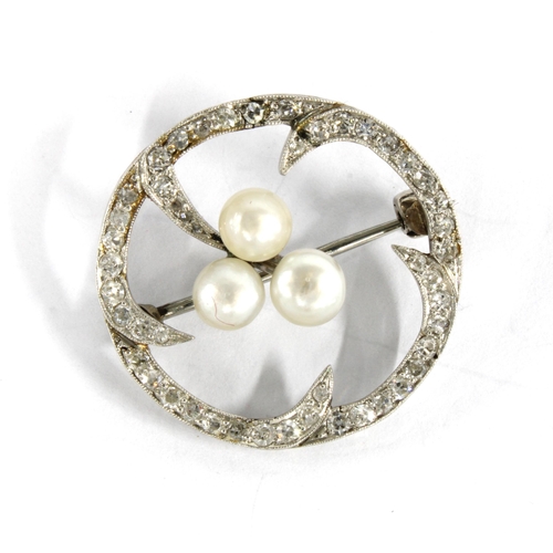 24 - Diamond and pearl brooch set in a circular  white metal open frame, unmarked, with a Hamilton & Inch... 