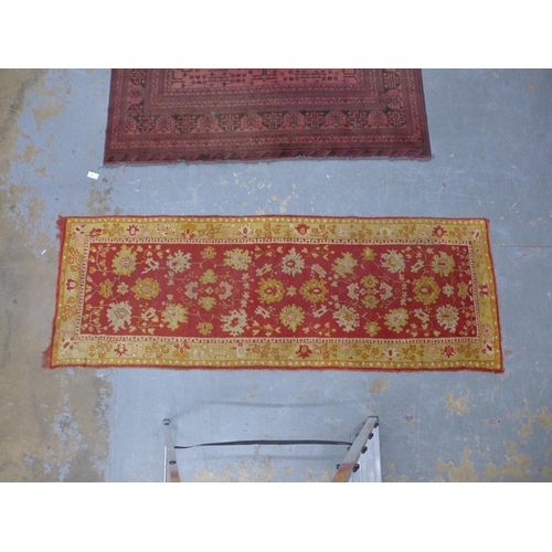 249 - Ushak runner, red field with foliate pattern within an orange border, 265 x 95cm.