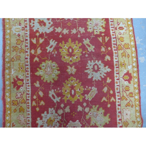 249 - Ushak runner, red field with foliate pattern within an orange border, 265 x 95cm.