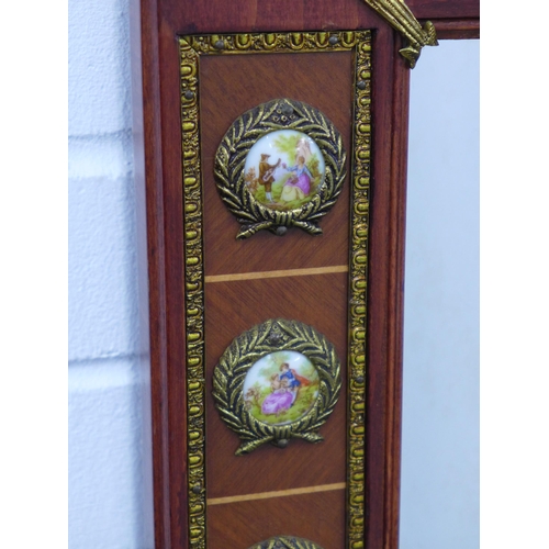 260 - An ornate reproduction wall mirror, parcel gilt with faux porcelain plaques, 54 x 88cm.