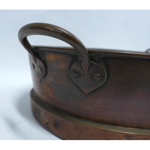 261 - A large copper pan, oval with handles, late 19th century, 58 x 34cm.