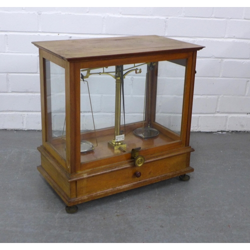 266 - Mahogany cased set of balance scales, 42 x 42 x 24cm.