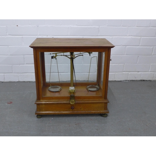 266 - Mahogany cased set of balance scales, 42 x 42 x 24cm.