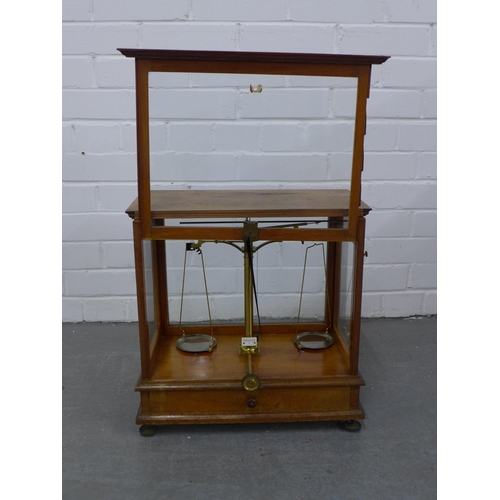 266 - Mahogany cased set of balance scales, 42 x 42 x 24cm.