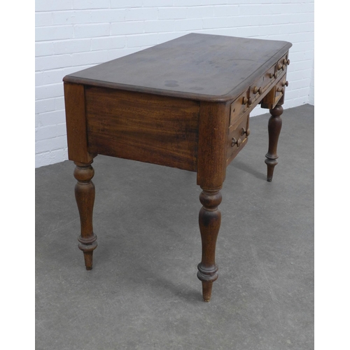 269 - Victorian mahogany desk with a central frieze drawer flanked by two short drawers, raised on turned ... 