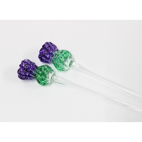 278 - Two coloured art glass swizzle sticks, in the form of thistles  14cm (2)