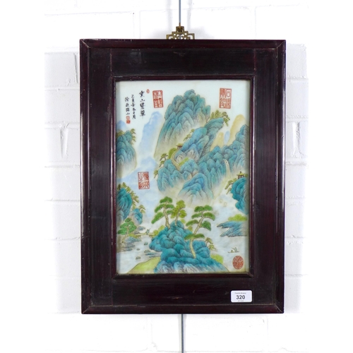 320 - Chinoiserie porcelain plaque with red seal marks, in a stylised rectangular frame, 25 x 35cm