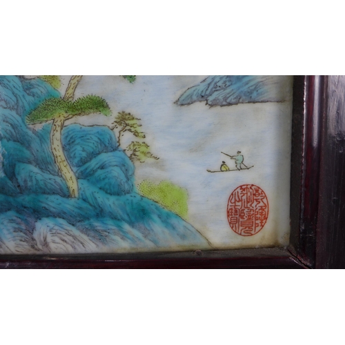 320 - Chinoiserie porcelain plaque with red seal marks, in a stylised rectangular frame, 25 x 35cm