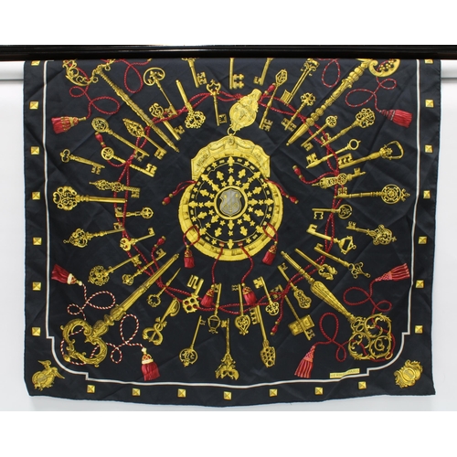 394 - HERMES LES CLES SILK SCARF, black  with red and gold pattern, together with another Hermes blue silk... 