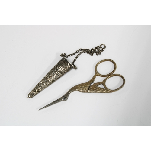 46 - An Edwardian silver chatelaine case, Chester 1903, containing a pair of 'stork' scissors (2)