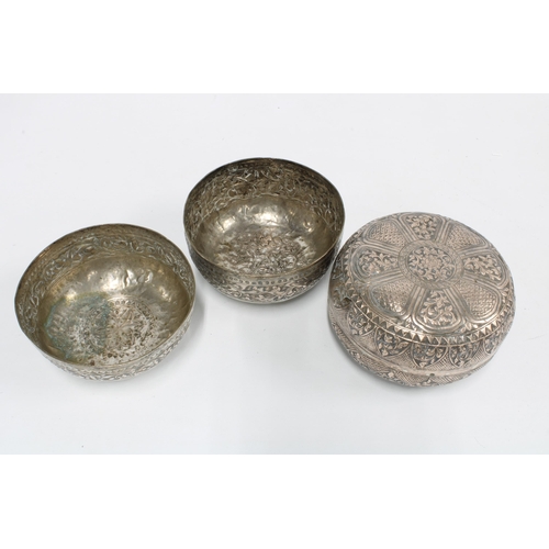 69 - A pair of Eastern white metal bowls with foliate pattern together with an Eastern white metal circul... 