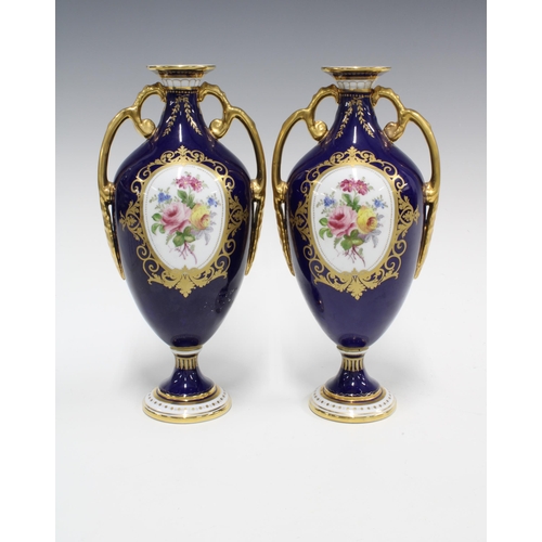 90 - Pair of Royal Crown Derby urn vases, blue ground and floral decorated panels, printed factory marks ... 