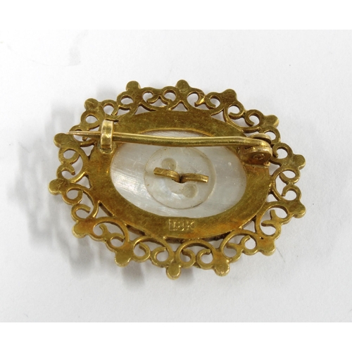 13 - Chinese gold brooch with an opalescent cabouchon within an openwork frame, stamped 18K,  2cm long