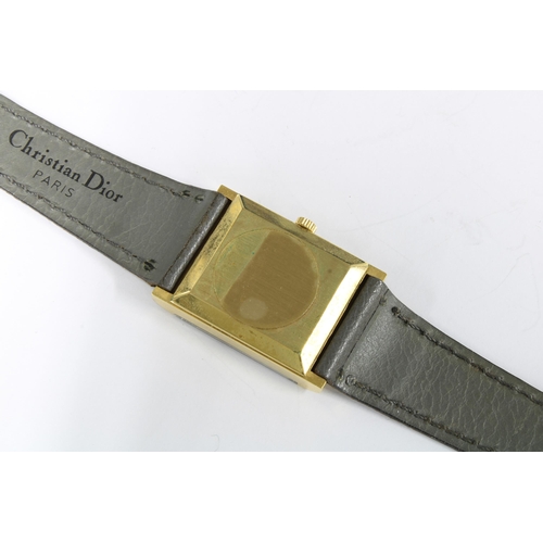 14 - Christian Dior gold plated wristwatch, signed tank dial, on a grey leather strap, complete with pres... 