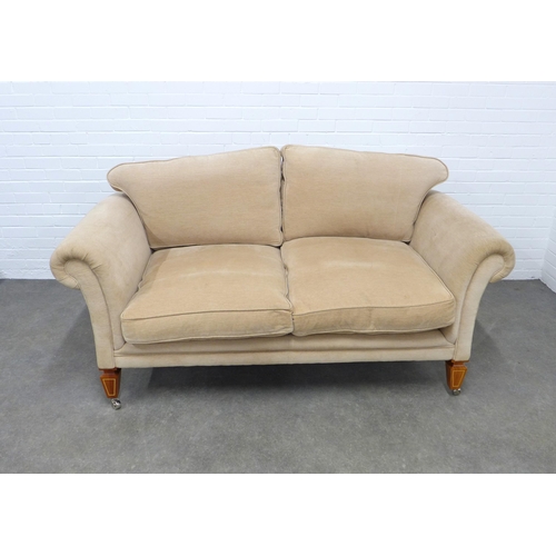 297 - DAVID LINLEY, LONDON, beige upholstered two seater sofa with scroll arms and loose cushion back, rai... 