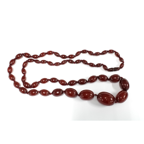 30 - A graduated strand of vintage cherry amber beads, largest bead approx 2.8cm