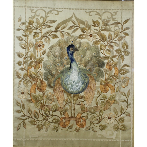 377 - Late 19th / early 20th century silk embroidery depicting a peacock within flowers and foliage, frame... 