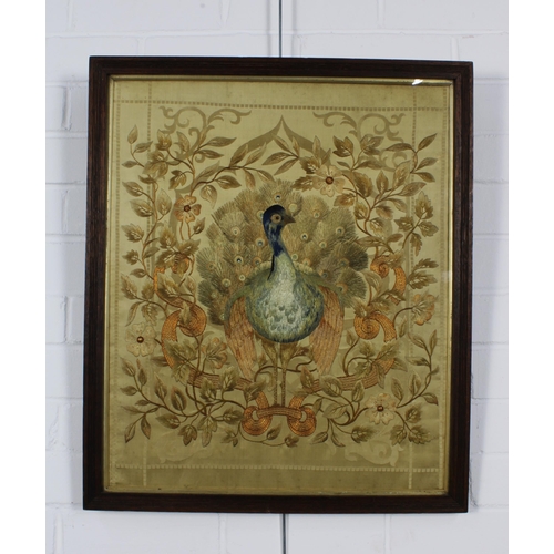 377 - Late 19th / early 20th century silk embroidery depicting a peacock within flowers and foliage, frame... 