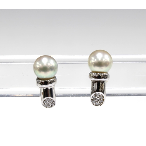 39 - A pair of  18ct white gold diamond and pearl earrings
