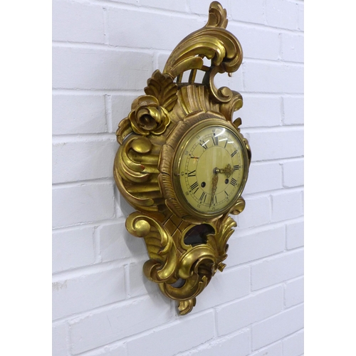 415 - Gilt Cartel wall clock by Exacta of Sweden, 32 x 60cm.