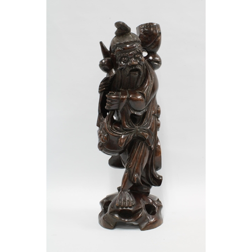 419 - A Chinese carved wood figure of a Sage, 42.5cm high