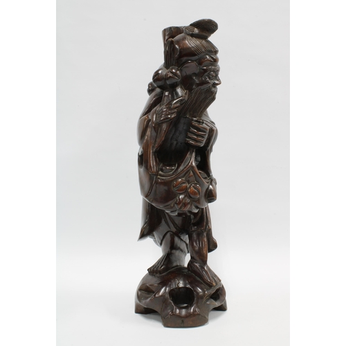 419 - A Chinese carved wood figure of a Sage, 42.5cm high