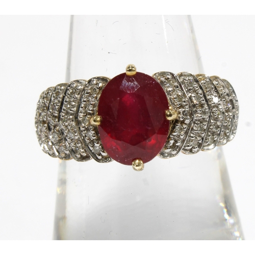 42 - 9ct gold ruby and diamond cocktail dress ring by Rocks & Co with an oval claw set ruby flanked by fi... 