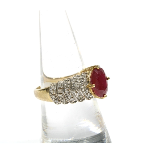 42 - 9ct gold ruby and diamond cocktail dress ring by Rocks & Co with an oval claw set ruby flanked by fi... 