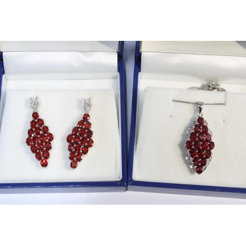 44 - 9ct white gold parure comprising a ruby and diamond dress ring, drop earrings and pendant necklace b... 