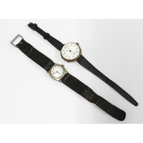 49G - Two early 20th century silver cased wristwatches, Arabic numerals and red 12, on black leather strap... 