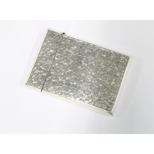 61 - An Edwardian silver card case, Smith & Bartlam, Birmingham 1908, with an allover pattern of leaves w... 