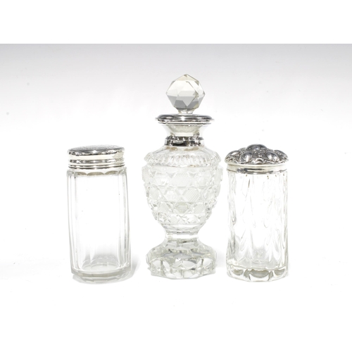 68 - Two silver topped glass jars and a silver collared glass scent bottle with stopper, London 1927, 12c... 