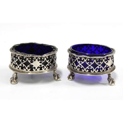 80A - A pair of Victorian silver salts, of large circular form with wavy rim and pierced design, raised n ... 